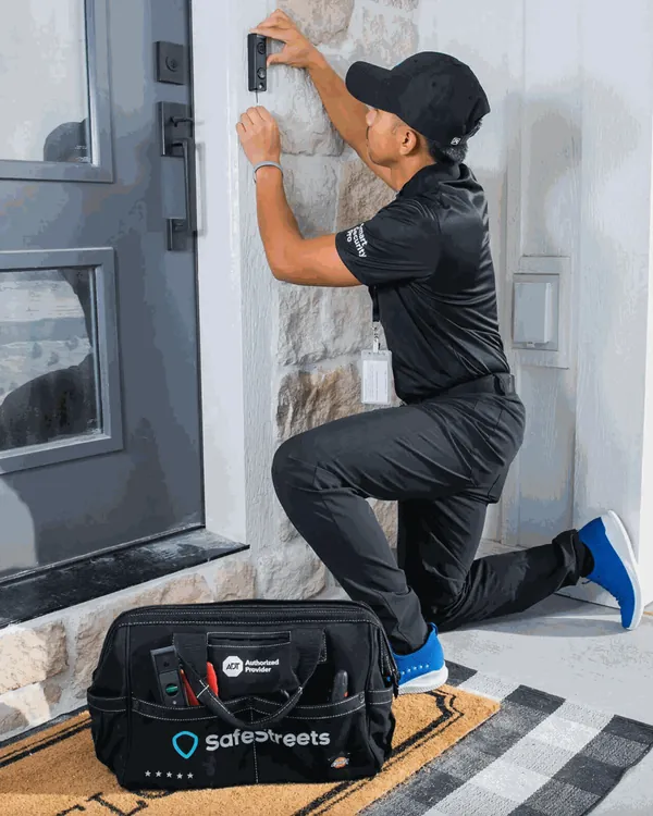 SafeStreets technician installing a doorbell camera